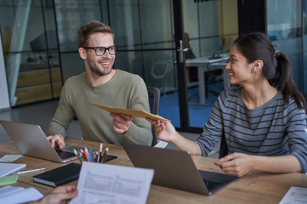Happy man and woman looking and holding envelope