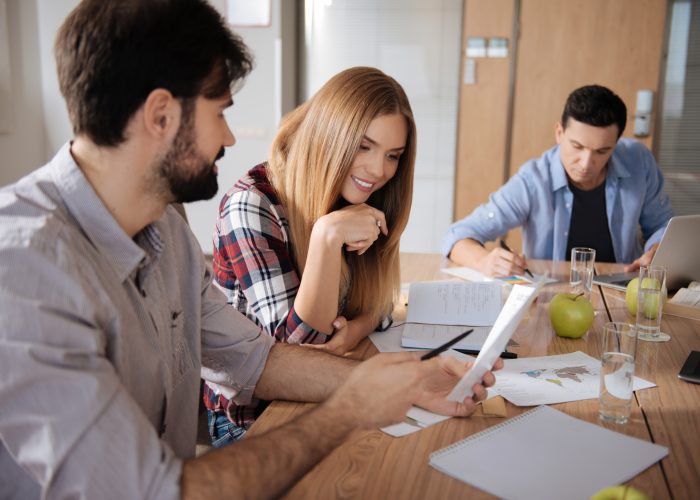 Positive young woman putting chin on her hand